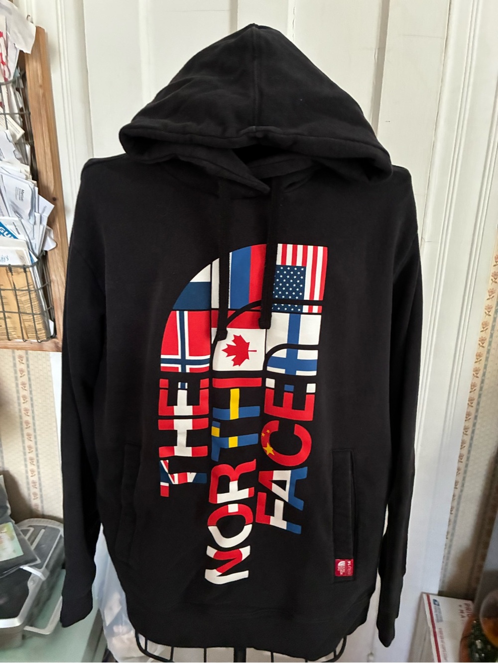 Men’s Size L The North Face Black Hooded Pullover with Multinational Flag Logo